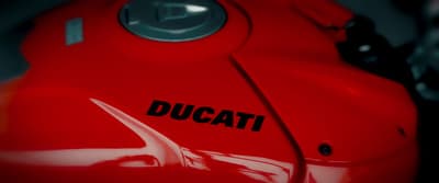 a close up of a red motorcycle with the word ducati on it