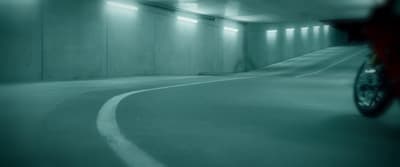 a person riding a bike in a parking garage