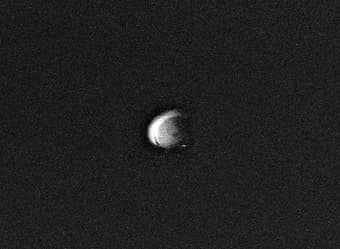 a black and white photo of a half moon