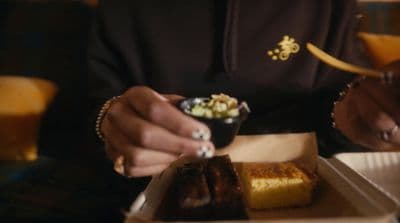 a person sitting at a table eating food