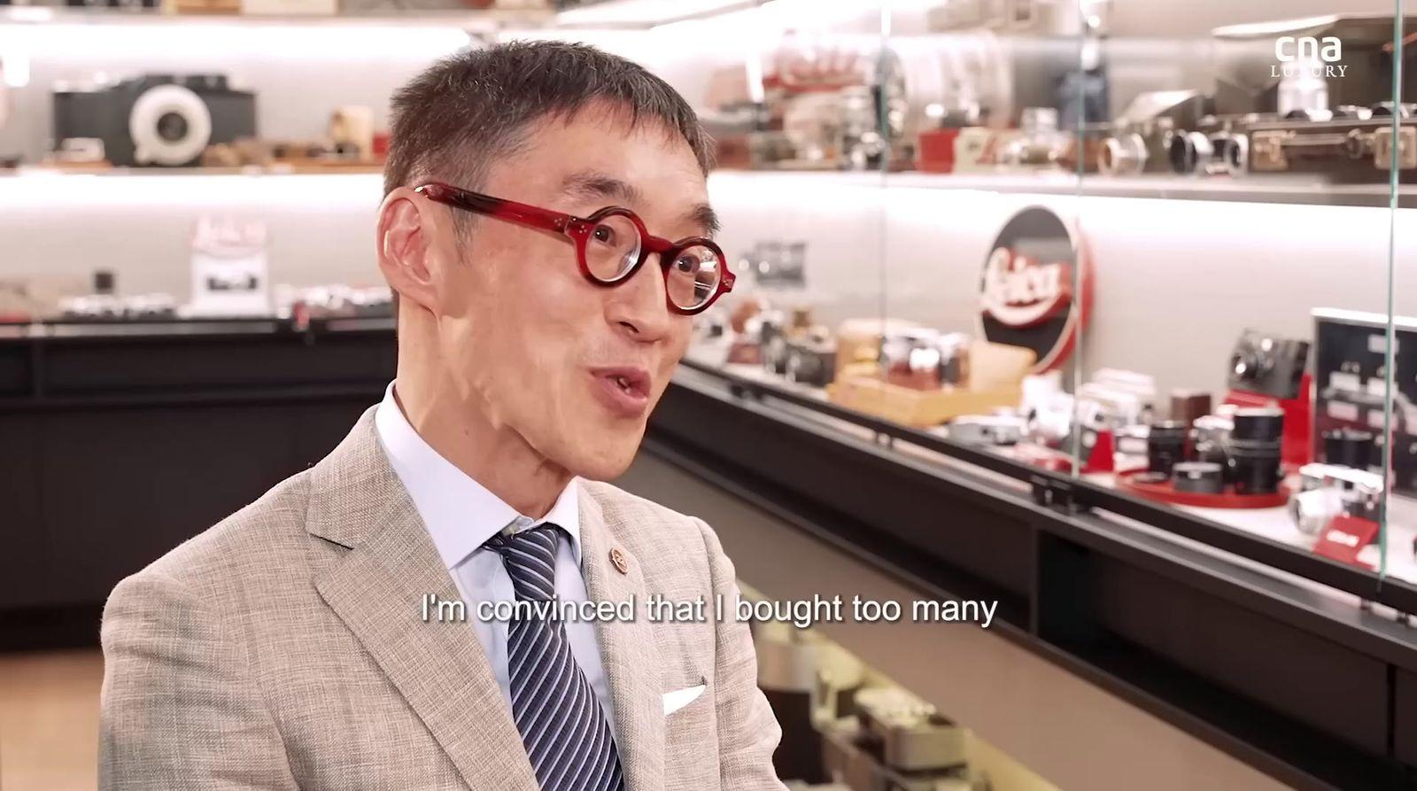 a man in a suit and tie wearing glasses