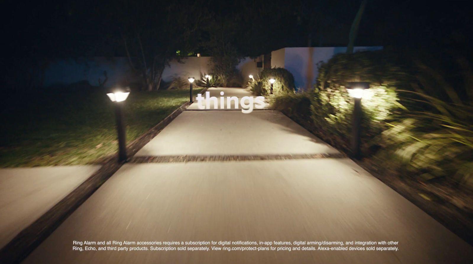 a walkway lit up with lights at night