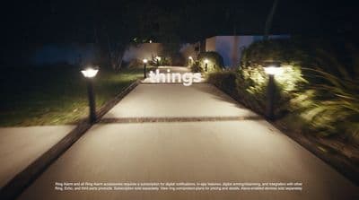 a walkway lit up with lights at night