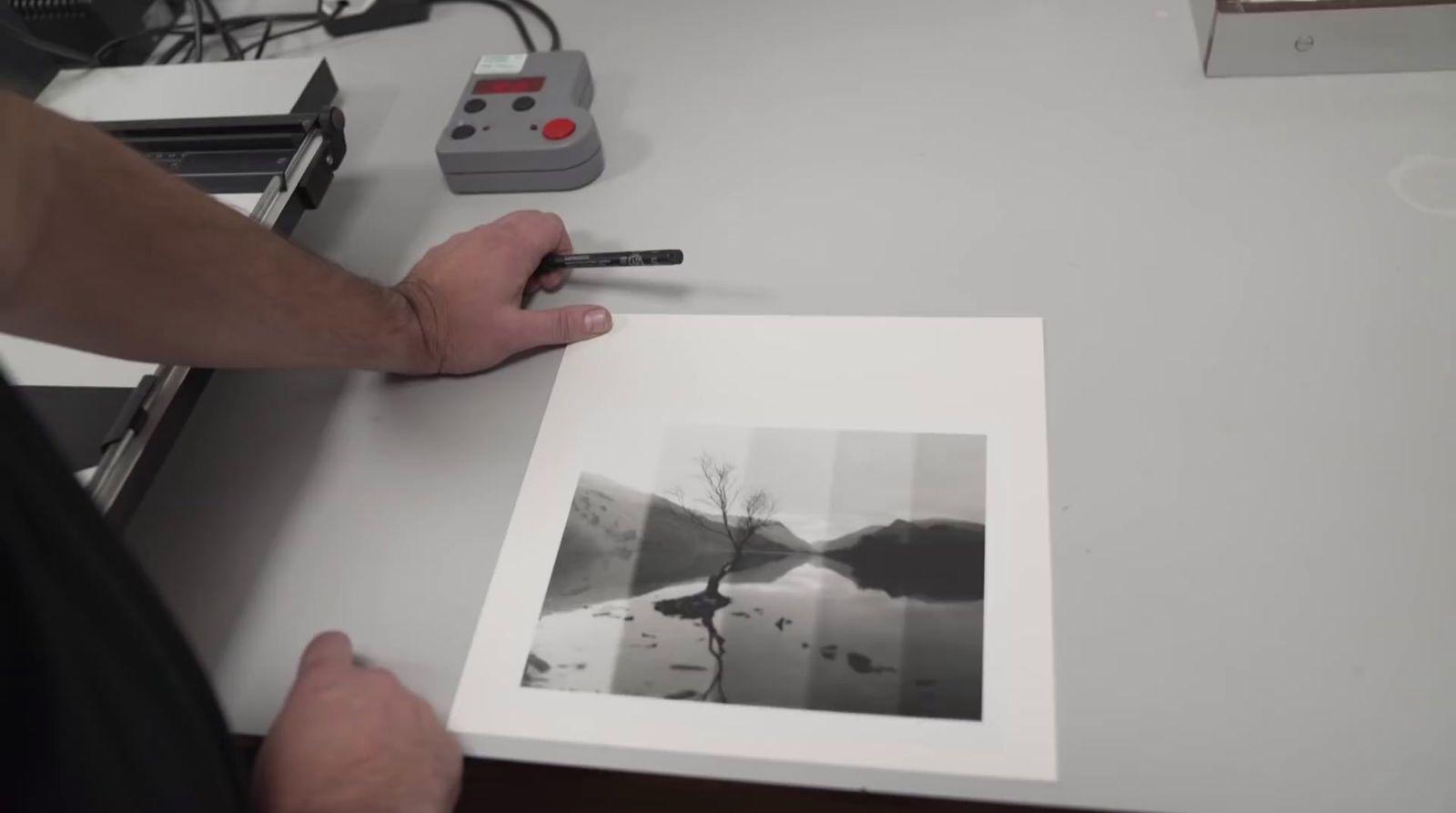 a person holding a pen and drawing a picture