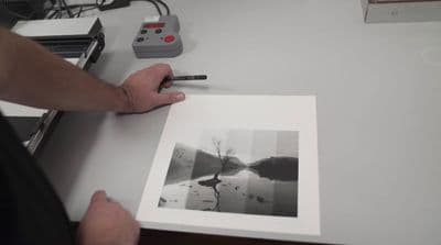 a person holding a pen and drawing a picture