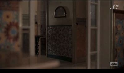 the hallway of a house with a clock on the wall