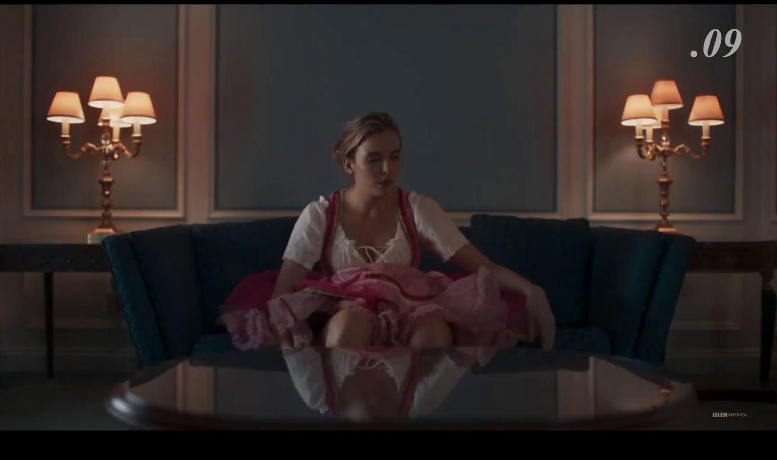 a woman sitting on top of a blue couch