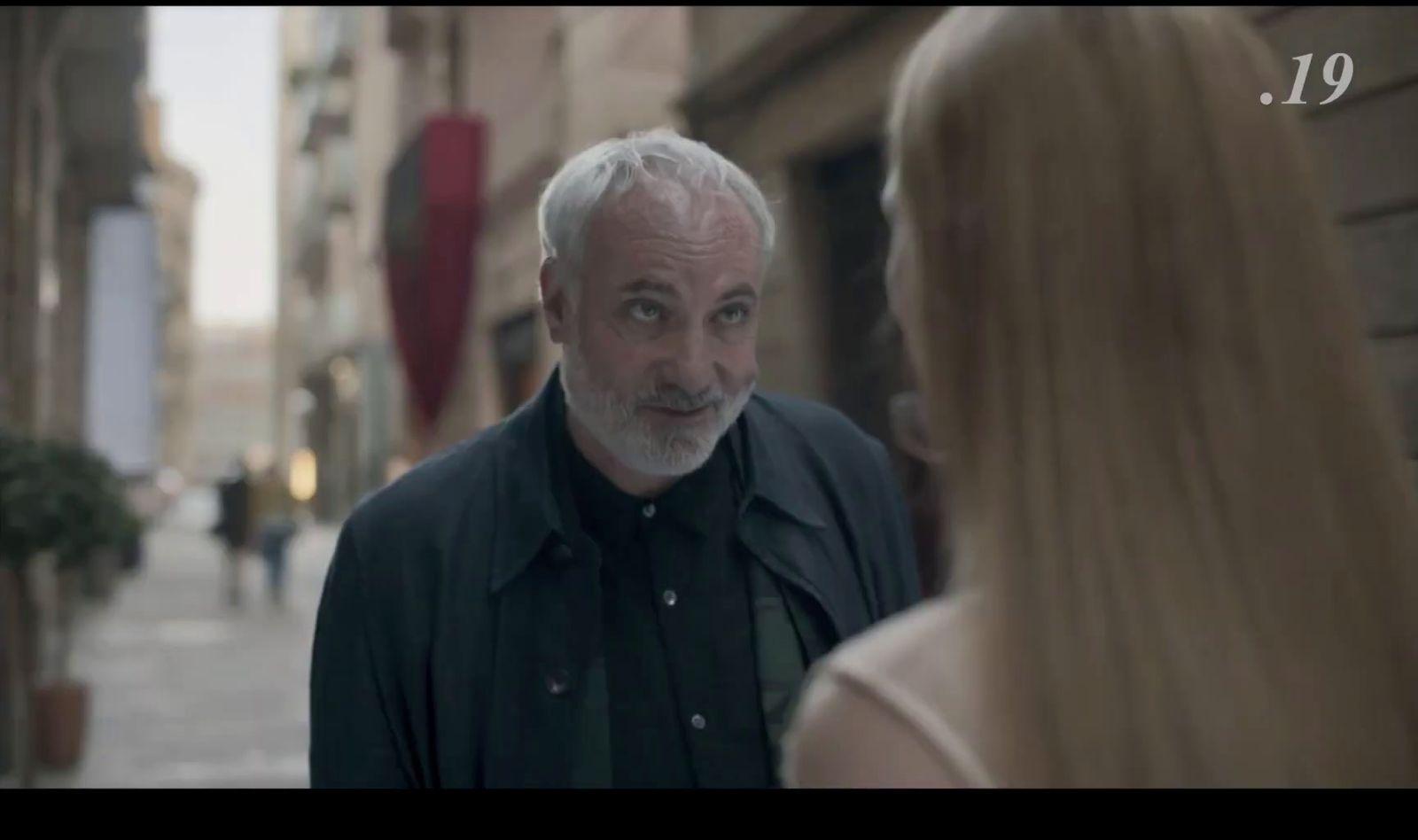 a man standing next to a woman on a street