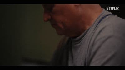 a man with glasses and a gray shirt