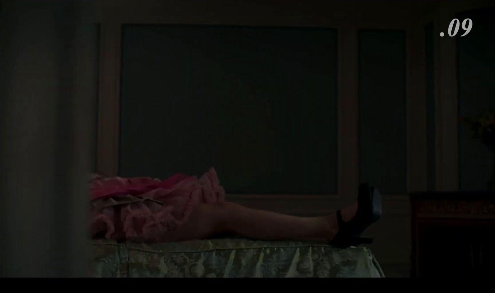 a woman laying on top of a bed in a room