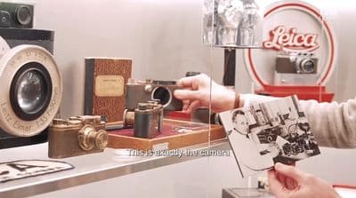 a person holding a camera in front of a mirror