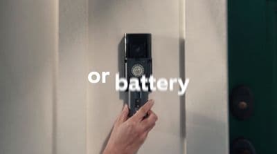 a person is holding a door handle with the word battery on it