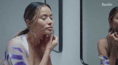 a woman looking at her reflection in a mirror