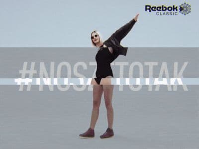 a woman in a short black dress is dancing