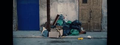 a pile of garbage sitting on the side of a road