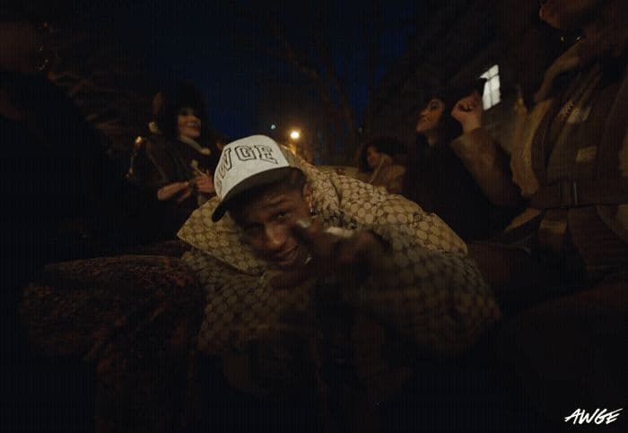a group of people standing around a man holding a cell phone