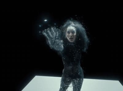 a woman standing on top of a white table under water