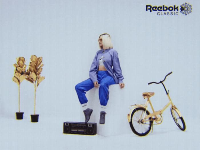 a man sitting on a box next to a bike