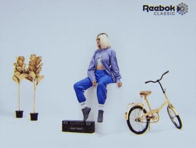 a man sitting on a box next to a bike