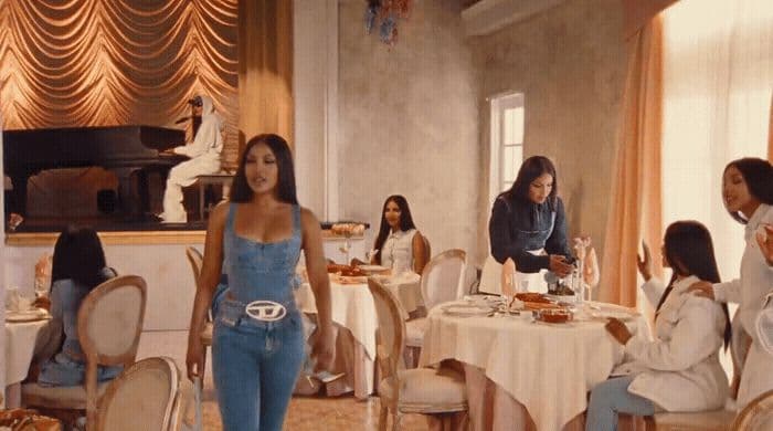 a group of women sitting around a table eating food