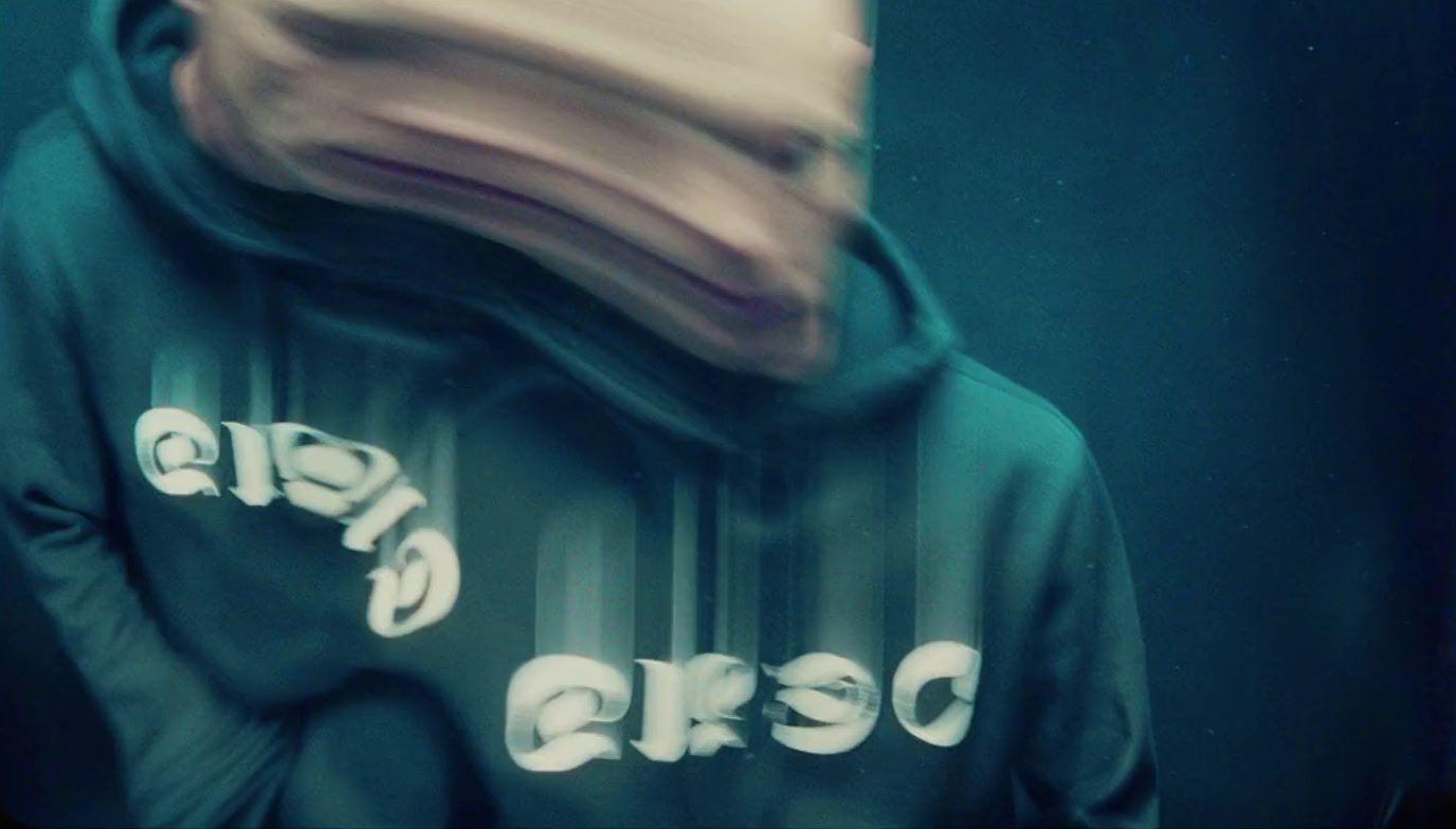 a blurry photo of a person wearing a hoodie