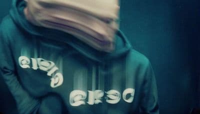 a blurry photo of a person wearing a hoodie