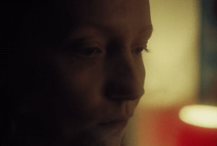 a close up of a person wearing a suit and tie