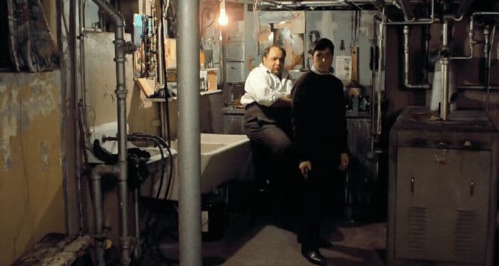 a couple of men standing next to each other in a room