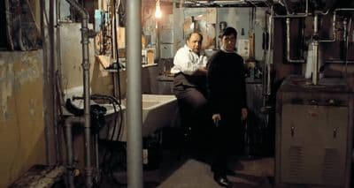 a couple of men standing next to each other in a room