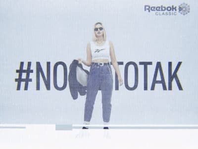 a woman standing in front of a no to talk sign