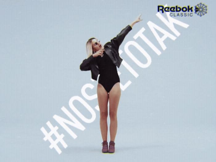 a woman in a black bodysuit is posing for a picture