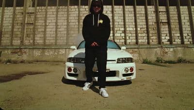 a man sitting on top of a white car