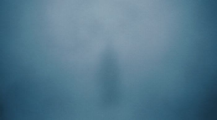 a person standing in the middle of a foggy room