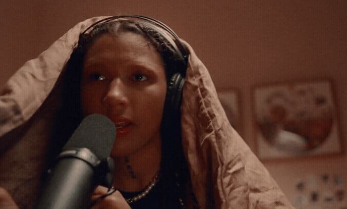 a woman with headphones on holding a microphone