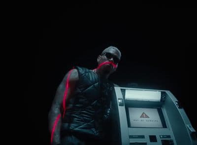 a man standing next to a machine in the dark