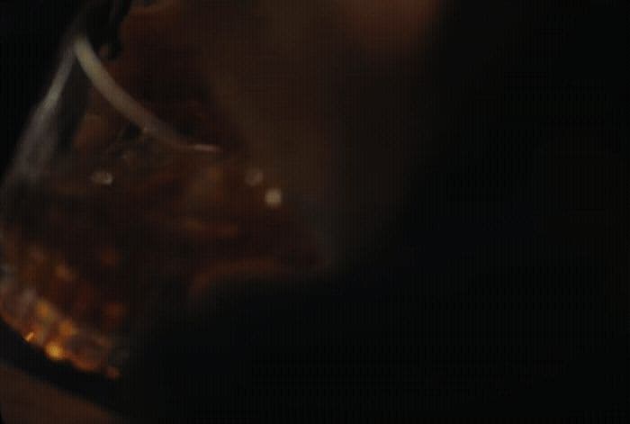 a close up of a person holding a wine glass
