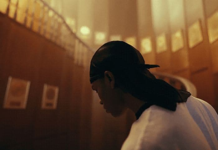 a woman in a white shirt and a black bow in her hair