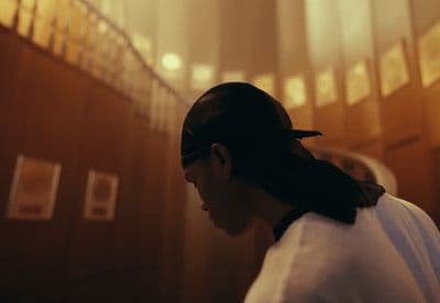 a woman in a white shirt and a black bow in her hair