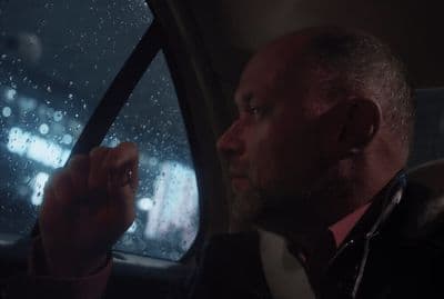 a man driving a car in the rain