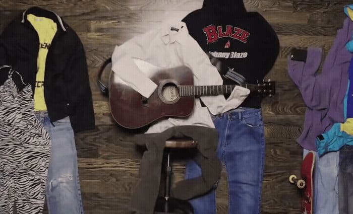 a group of clothes and a guitar are hanging on a wall
