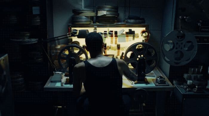 a woman standing in front of a machine in a dark room