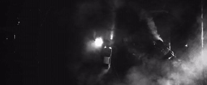 a black and white photo of a person in the dark