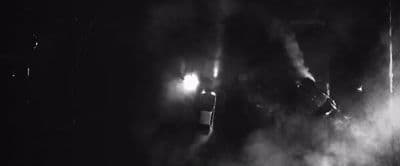 a black and white photo of a person in the dark