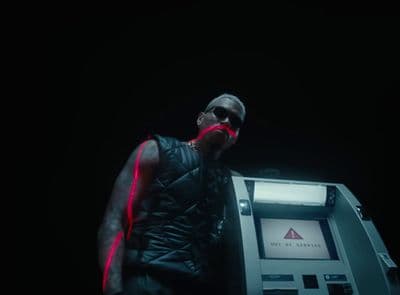 a man standing next to an atm machine