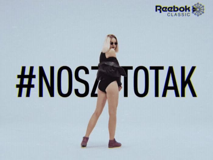 a woman in a black bathing suit is dancing
