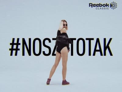 a woman in a black bathing suit is dancing