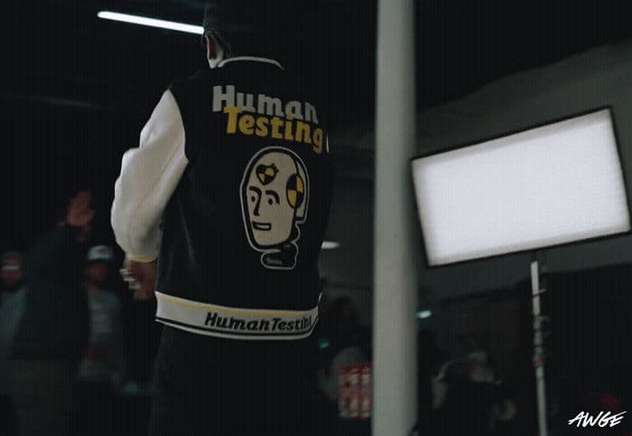 a man wearing a vest that says human testing