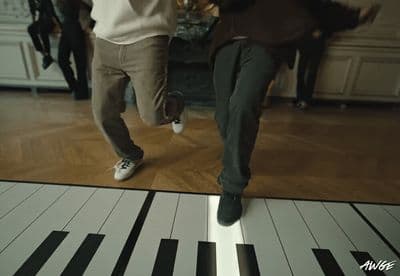 a couple of people that are standing on a piano