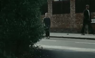 a couple of men walking down a street
