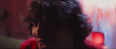a blurry image of a man with long hair